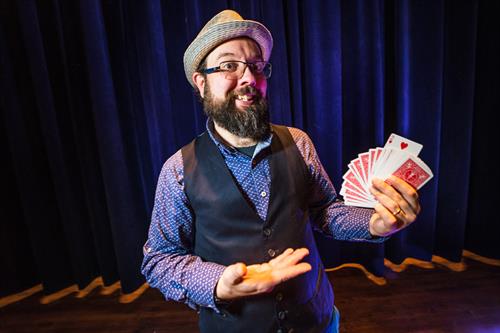 Wayne performing some card magic at a corporate event.