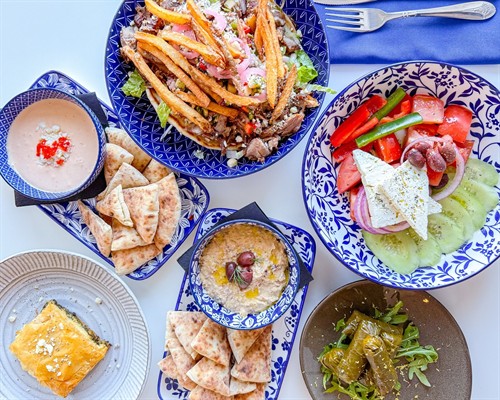 A table full of colorful Greek dishes made for sharing