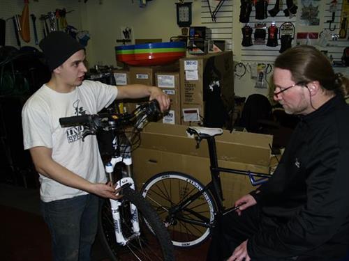 Mechanic Devin Clancy with customer Mechanic Devin Clancy with customer