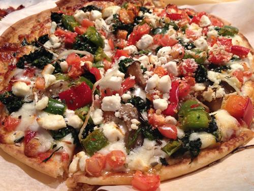 Mediterranean Veggie Pizzotto. 9" Grilled Flatbread Pizza topped with sauce, cheese, onions, peppers, tomatoes, spinach, eggplant, kalamata olives and feta. 
