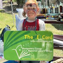 Young Patron photo with the giant Library Card at Freedom Fest!