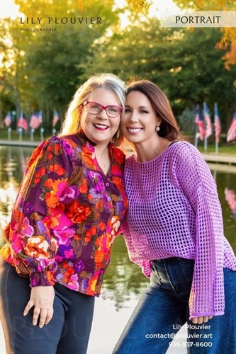Fall family portrait of a mother and daughter on a tree-lined path in The Woodlands