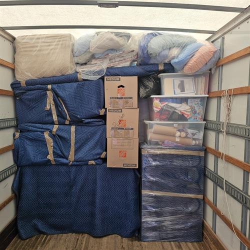 Loaded Moving Truck with boxes and wrapped furniture