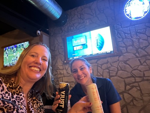 Gallery Image Two_women_enjoying_drinks_and_smiling_at_the_bar_during_a_night_out_at_Escape_In_Time_and_Axe_Throwing_in_The_Woodlands._Texas.jpg