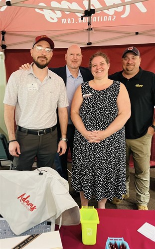 Team photo at our booth at Adams breakfast sponsor event 