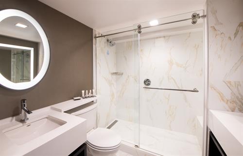 Spa-like bathrooms in our Beverly Hills hotel feature granite countertops and waterfall showers Spa-like bathrooms in our Beverly Hills hotel feature granite countertops and waterfall showers