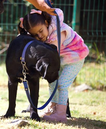 Pia hugging her service dog during a training session