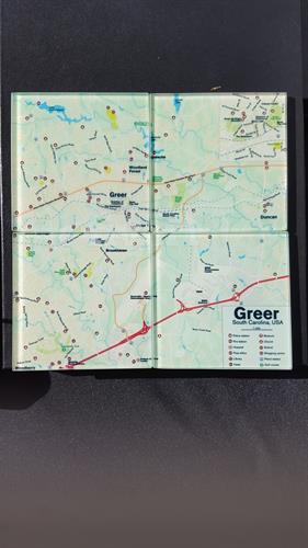 4 Glass coasters when placed together show a map of the greater Greer area.