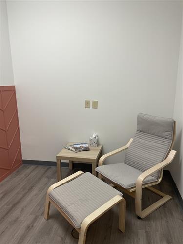 Our favorite room in the office is the mom's room, outfitted with a fully stocked changing table and a relaxing chair perfect for mom and baby to take a minute and relax following their adjustment. 