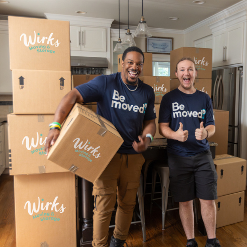 Two happy Wirks employees pack the kitchen