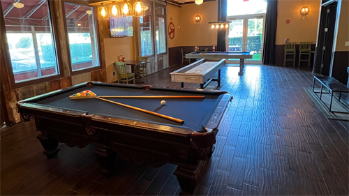 Our event room containing; two pool tables, shuffleboard and outside seating area