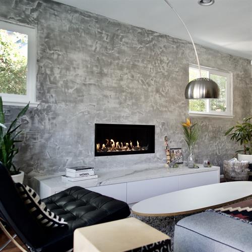 A modern fireplace remodel transforms the room with clean lines and a warm, inviting focal point.