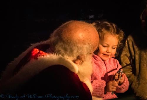 Little girl on Santas lap, Holiday Tree Lighting 2017