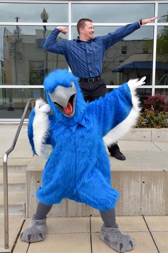 RCC's mascot, Ossie the Osprey, posing with staff.