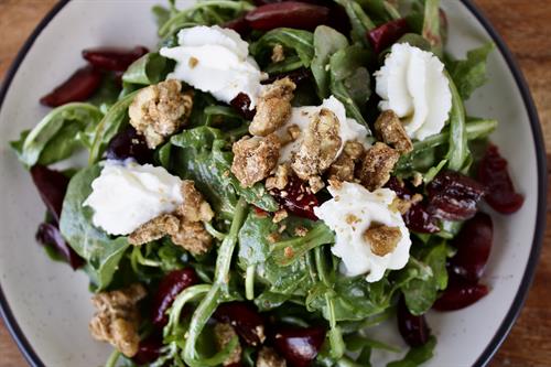 Blossom Barn Dinner | Spring arugula with house-pickled orchard cherries, whipped goat cheese, and candied walnuts, finished with a bright cherry vinaigrette. Blossom Barn Dinner | Spring arugula with house-pickled orchard cherries, whipped goat cheese, and candied walnuts, finished with a bright cherry vinaigrette.