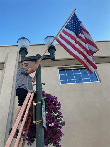 Helping Kiwanis put up flags downtown.