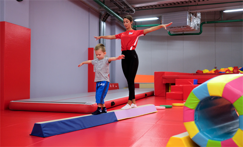 Balancing on the soft low beam — building coordination, focus, and confidence through fun movement!