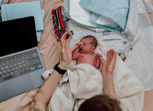 Gentle newborn exam at a home birth. Photo by Erin Loughlin. 