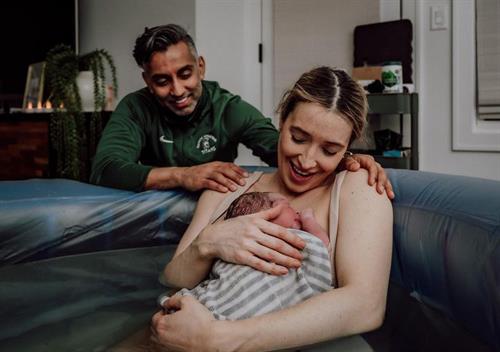 Happy parents after a joyful home birth. Photo by Erin Loughlin. 