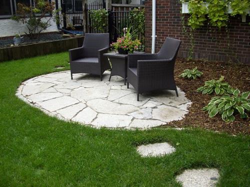 A flagstone patio and landscape installed by Barrett Lawn Care