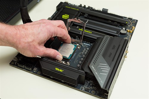 Technician installing a CPU into a motherboard.
