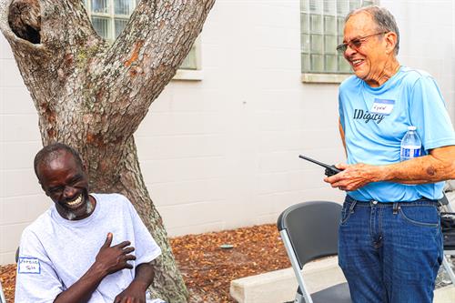 Volunteer Lynn and client Eugene bond during an Identification Service Day.