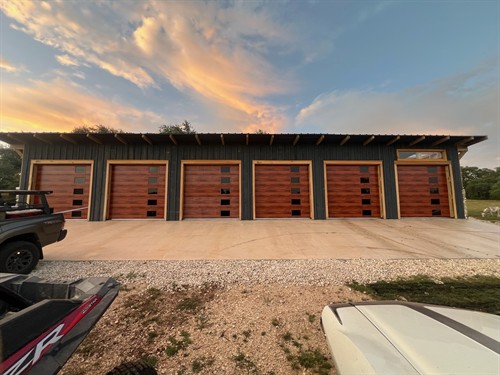Plank design garage door with cedar woodtone color and stacked windows