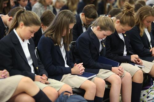 Logic School Students Pray at Weekly Assembly