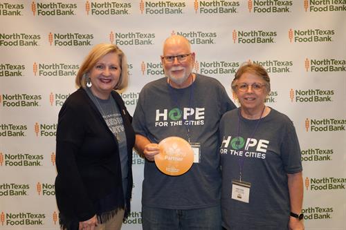 Dave and Kathy recieving the North Texas Food Bank award for the Emergent Food Pantry for Collin County in 2024.