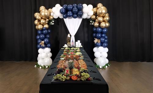 Celebrating life’s moments with style—balloon décor and a custom grazing table setup. 