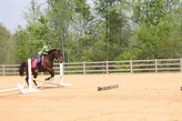 Student getting lesson in outdoor arena