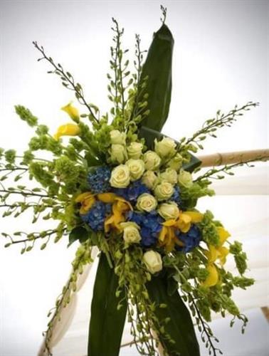 Wedding ceremony decor using blue hydranges, roses and various blooms.