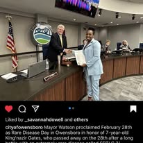 Lakeia Nard receiving Owensboro Proclamation for Rare Disease Day in Honor of King'Nazir Gates.