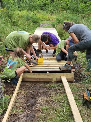 Volunteers building bridges on our Arundel Community Trails