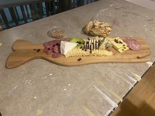 Hand crafted whale charcuterie board, with wine glass holder. Our classes always have good food, and good people!