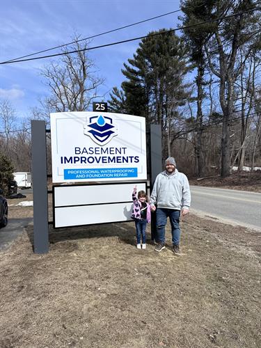 Owner Cory and his daughter Maeve proudly showing off the brand new BI road sign.