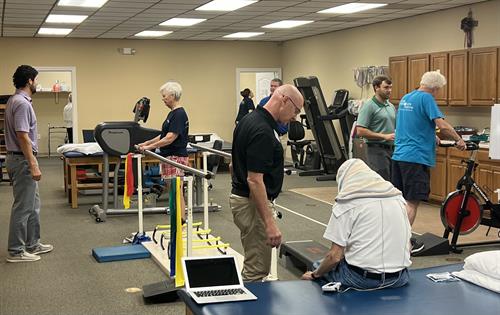 Large gym floor with multiple equipment options for personalized therapy