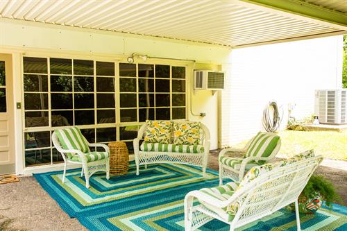 The patio has a cheerful feel overlooking a large, private backyard.