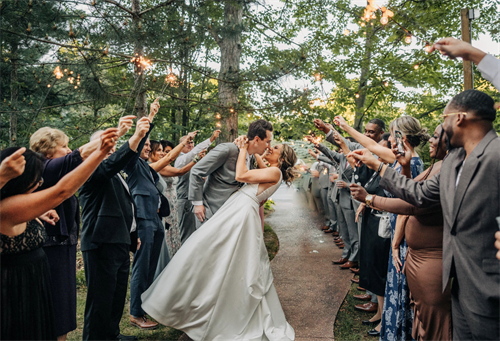 Bride and Groom Sparkler Send-off with wedding guests
