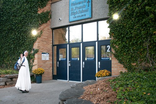 Sister walking into St. Francis High School