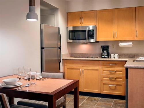 Studio suite fully equipped kitchen with pots, pans, dishes, and more