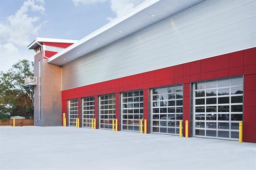 Clopay full-view commercial garage doors providing modern style and visibility for businesses in Danbury and New Milford, CT.