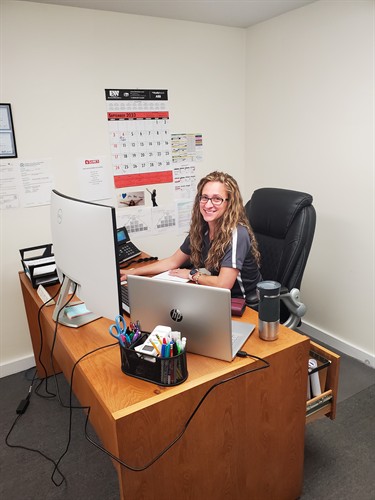 Office manager working on permits, HR and company events.