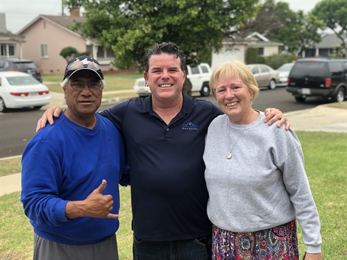 John Medina with a family after a smooth, no-hassle cash home sale.