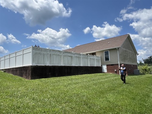 BEFORE — Cookeville house washing: siding and vinyl fence.
