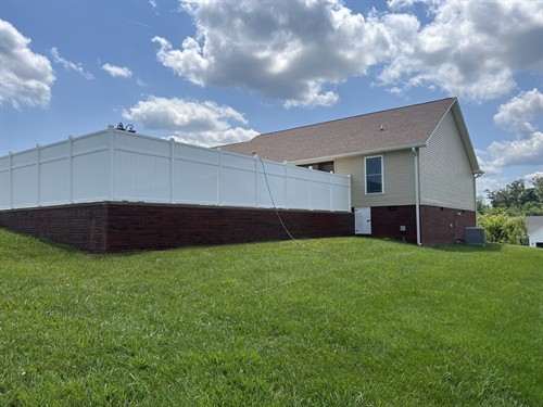 AFTER — Cookeville house washing: siding and vinyl fence.