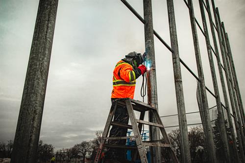 BestWay Fence systems building a 40' tall backstop.