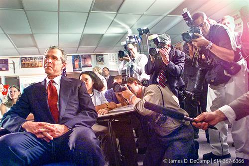 Republican Presidential candidate George Bush sits in a classroom at Westerville South High School and watches his wife on CSPAN giving a speech at the Republican National Convention in Philadelphia. The backdrop to Bush is the national press corps on the right, and students from Westerville South on the right. (© James D. DeCamp | http://www.JamesDeCamp.com | 614-367-6366)