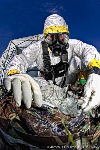 Sgt. Nick Landis collects a sample of white powder from some contaminated clothing as members of the Illinois National Guard dig victims out of a rubble pile during a scenario with the 52nd Weapons of Mass Destruction Civil Support Team during a drill at the Muscatatuck Urban Training Center in Indiana.  (© James D. DeCamp | http://www.JamesDeCamp.com | 614-367-6366)