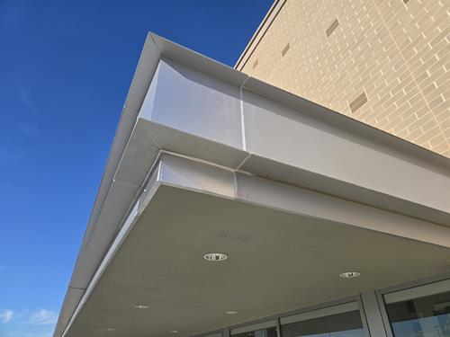 Manufactured and installed metal panel and painted overhang and panel to match